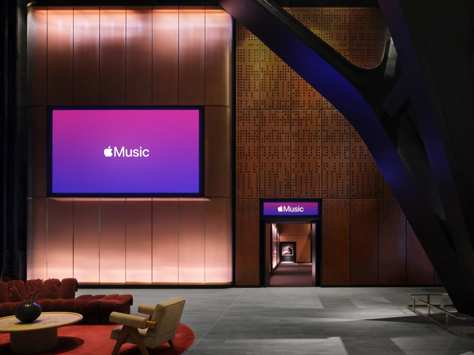 Le foyer contemporain de l’Apple Music Hall avec ses murs métalliques et son éclairage bleu.