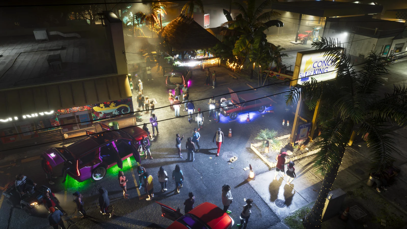 Image officielle de GTA VI vue en plongée : une fête de rue nocturne à Leonida, des voitures portières ouvertes éclairées au néon vert et violet, une foule entre les palmiers.
