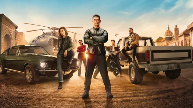 Image officielle de Matchbox – Le film : les héros devant des voitures et un hélicoptère.